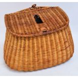 A wicker fishing creel of bellied form with canvas and leather strap, width 36cm.