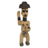 A Punu-Lumbo female figure, Gabon, with traces of kaolin, unusual helmeted coiffeur,