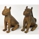 A matched pair of 17th century Benin bronze seated leopards with punched and raised decoration,