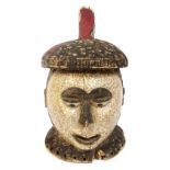 An Idoma helmet mask, Nigeria, with traces of polychrome decoration and kaolin,