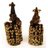 A pair of Yoruba Ibeji figures, Nigeria, each modelled with exaggerated cheeks,