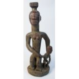 A large Zaramo mother and child figure group, Tanzania, height 68cm, width 25.5cm, depth 20cm.