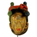 A Yoruba Gelede mask, set with two twin headed snakes centred with a lizard,