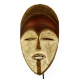 A Vuvi spirit mask, Gabon, with red pigmentation to the forehead and kaolin to the face,