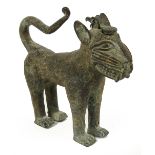 An 18th century Benin bronze model of a leopard with pivoting plug to the head and modelled four