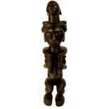 A Fang figure, Gabon, modelled as a figure supporting a child upon their shoulders, height 64cm,