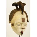 An Ogoni spirit mask, Nigeria, with bird surmounted to the top,