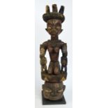 A Yoruba "Epa" headdress, Nigeria, raised on a stepped square section base,