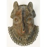 A 17th century Benin bronze leopard mask with punched and raised decoration and ring loop