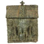 A 14th century Benin bronze deep wall plaque with roof, decorated with four standing figures,