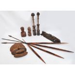 A collection of carved wooden tribal African items comprising two attenuated figures,