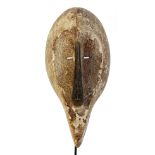 A Fang Ngil mask, Gabon, of elongated form and decorated with kaolin,