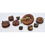 A large wooden "Seareel", 9", a similar smaller example, 7", four strap back reels,