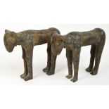 A pair of 16th century Benin bronze models of "grinning" goats modelled four square, length 34cm,