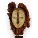 A Lega Bwami society mask, Democratic Republic of the Congo, with six applied metal discs,