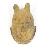 A 17th century Benin bronze leopard mask with punched and raised decoration and border of ring