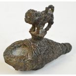 An 18th century Benin bronze small model of a leopard modelled standing on an upturned snail shell,