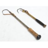 Two early 20th century gaffs, one with cork handle and one with moulded handle.