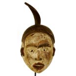 A Yombe spirit mask, Democratic Republic of the Congo, with unusual twisted spike, kaolin,