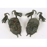 A pair of 17th century Benin bird of ill fortune masks,