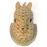 A 17th century Benin bronze leopard mask with "spotty" and punch decoration with ring loop