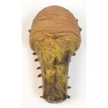 A 19th century Benin bronze baboon hip mask with ring loop attachments to the rim, length 23cm.