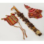 A tribal knife in painted scabbard with small additional blade and bead adornments,