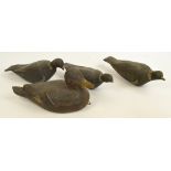 Four carved and painted wooden decoys comprising a duck, length 36cm and three pigeons,