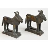 A pair of 18th century Benin bronze models of goats standing four square on pierced rectangular