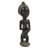 A Luba maternity figure, Democratic Republic of the Congo, modelled as standing female with infant