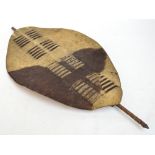 An African Zulu shield with cow hide covered body with wooden staff to the reverse. CONDITION