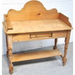 A Victorian stripped pine washstand on turned legs and a lower shelf, length 110cm.