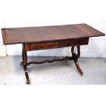 A reproduction mahogany sofa table with two central drawers on lyre supports and brass feet,