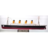 A small kit built model on stand of R.M.S Titanic, length 67cm.