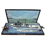 A painted scratch built diorama of a gun ship at sea with bell and anchor set to the front and