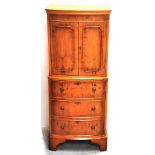 A reproduction yew wood bow fronted cocktail cabinet, 54.5 x 131.5cm.