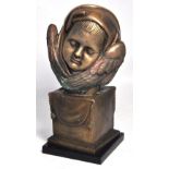 A composite bust of a child's head on square plinth and raised on a marble base,