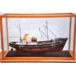 A detailed static scale model of a trawler bearing the number "223",
