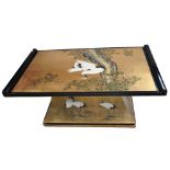 A modern Oriental style ebonised and gilded table decorated with cranes and prunus on a rectangular