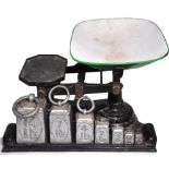 A set of early 20th century scales together with a set of graduated weights.