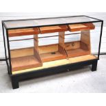 A 20th century black painted wooden and glass shop counter type display cabinet,