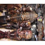 A vintage suitcase containing a quantity of African tribal carvings to include statues,