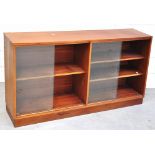 A modern teak bookcase with double sliding glazed doors, 76 x 134cm.