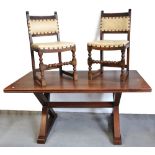 An oak priory style dining table on cross supports and six matching carved dining chairs,