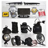 A quantity of motoring memorabilia to include vintage AA car badges, vintage head lamps,