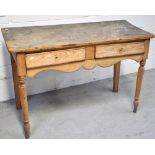 An Edwardian two drawer pine kitchen table on turned legs, length 120cm.