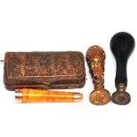 A 9ct gold and amber cased cheroot holder and two late 19th / early 20th century seals.