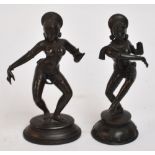 Two similar 19th century Indian bronze dancing deities, one on lotus decorated base, height 14cm.