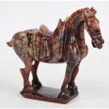 An early 20th century Chinese veined hardstone figure of a horse standing four square, height 17.