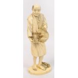 A fine Japanese Meiji period carved ivory okimono depicting a man holding a hare, Tokyo school,